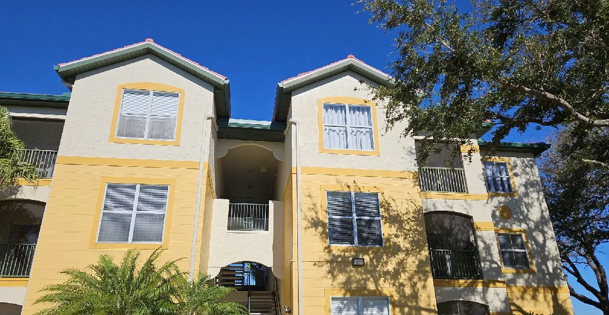 New 7-inch forest green seamless gutters on three-story condo buildings in Fort Myers, FL