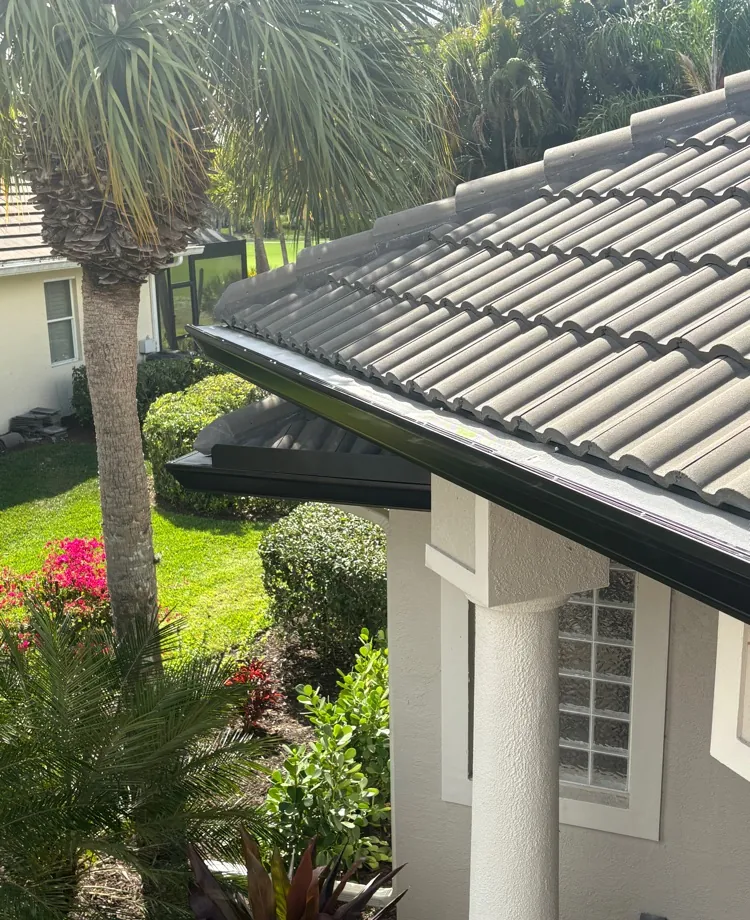 Black One Gutter Guard on new 7-inch black seamless gutters under a tile roof in Estero, FL