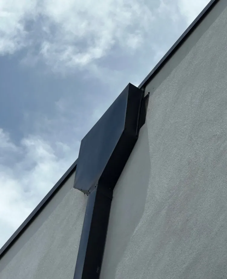 Close-up of a bronze conductor head and downspout in Fort Myers Beach, FL