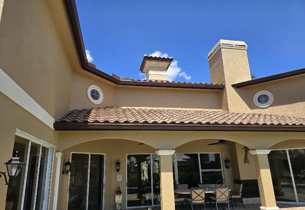 Brown seamless gutters on a two-story tile-roof home in Cape Coral