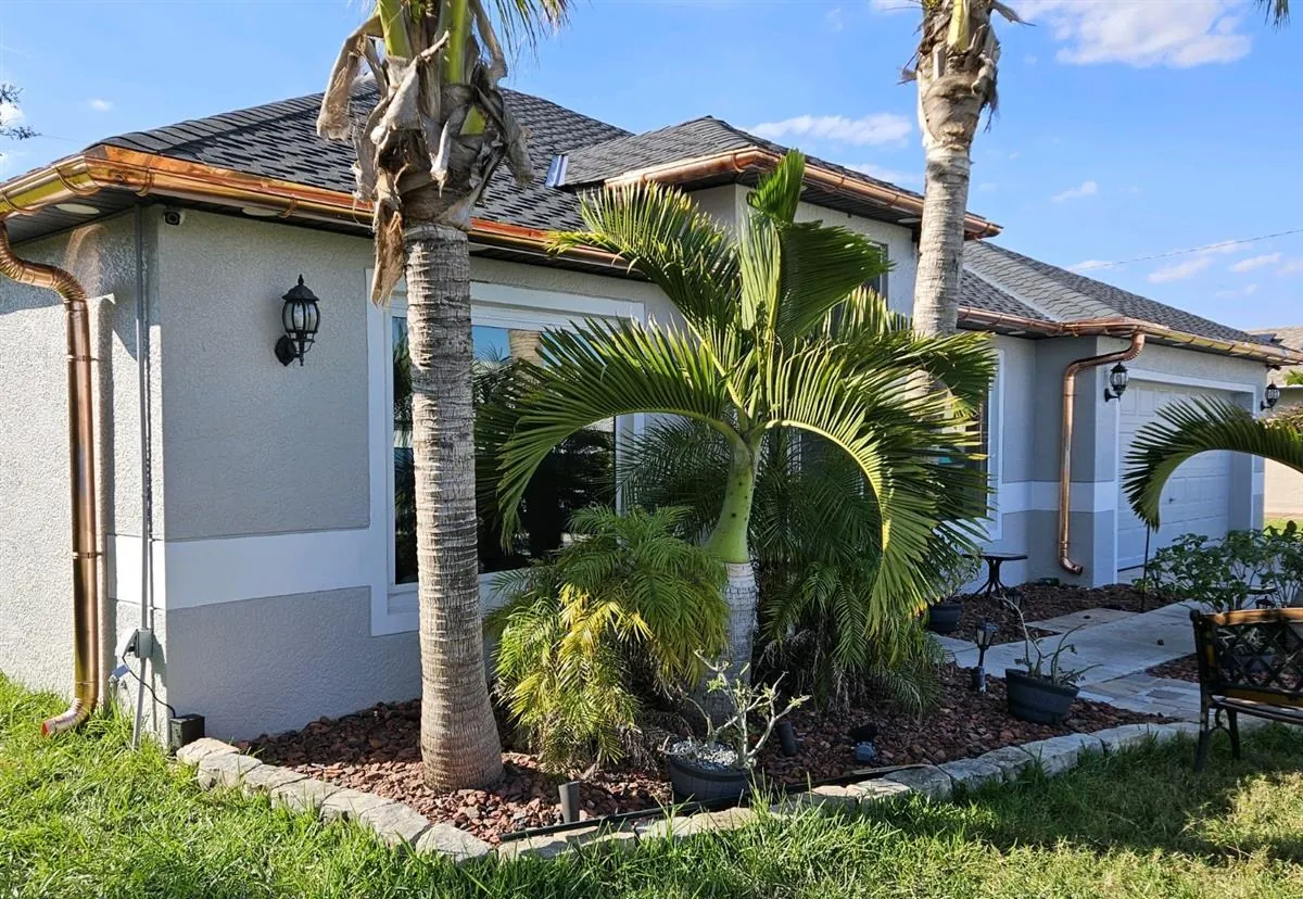 Copper seamless gutters and downspouts on a single-story home in Cape Coral, FL