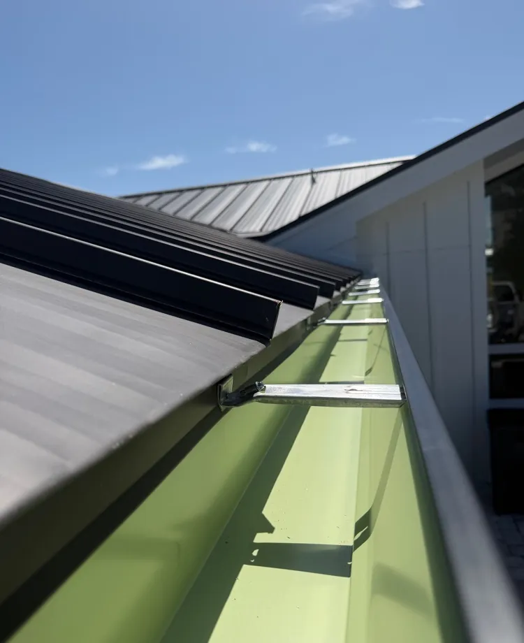 Close-up inside a dark bronze seamless gutter in Sanibel, FL
