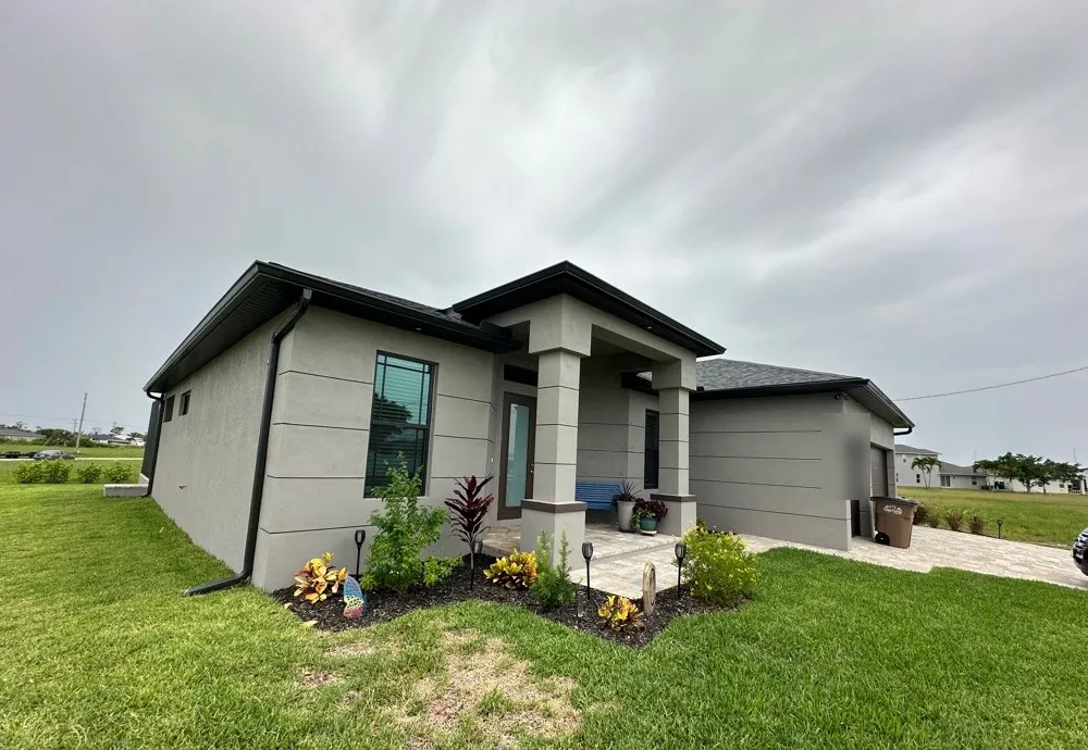 Dark bronze seamless gutters on a new-construction home in NW Cape Coral