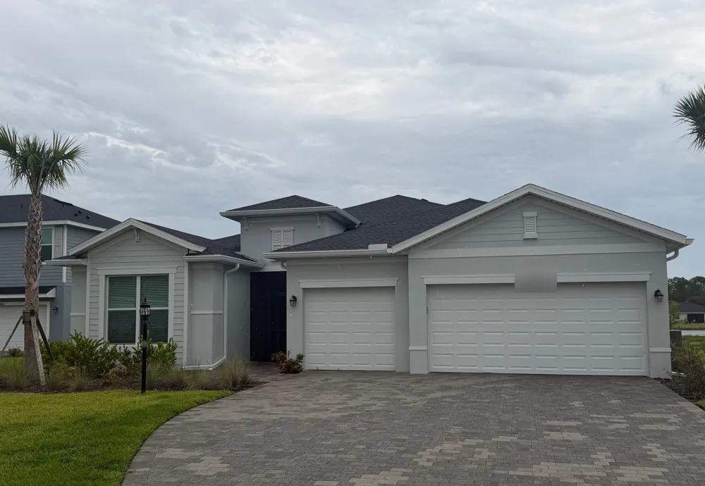Light gray stucco home with new white seamless gutters in North Fort Myers, FL