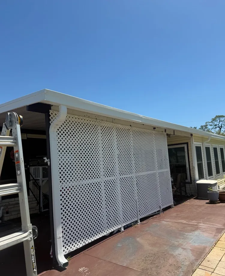 New white 5-inch roll-formed box gutter and valance with downspout on a carport in North Fort Myers, FL
