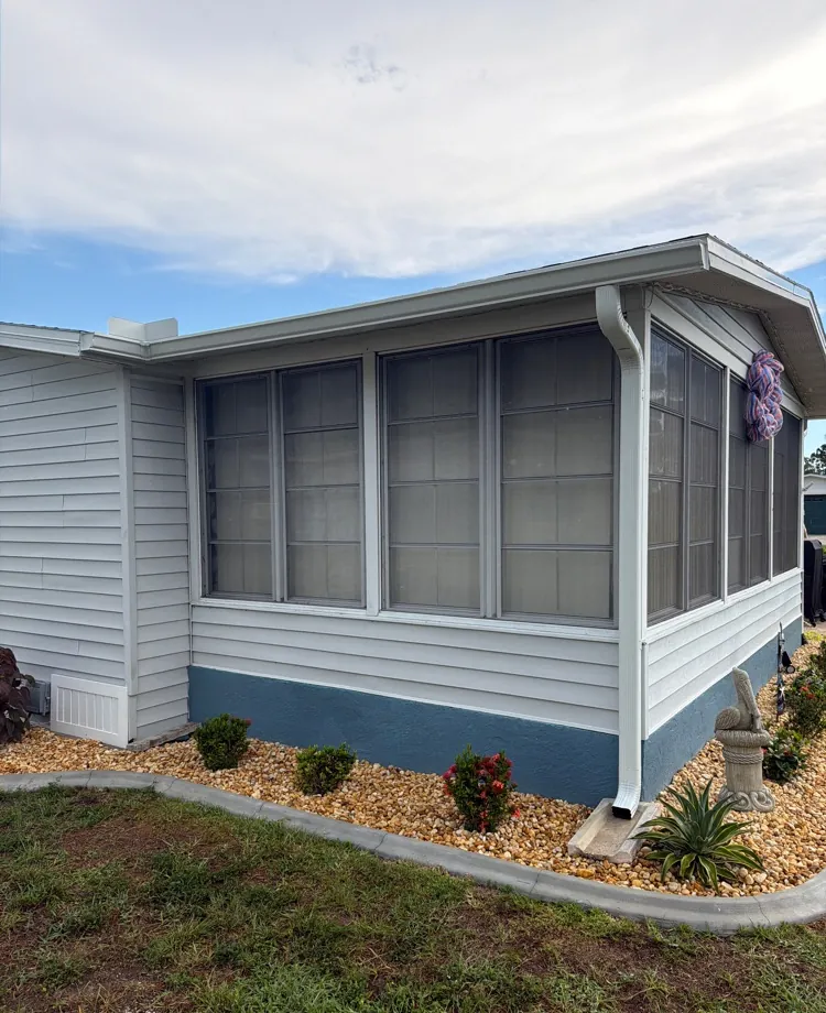 White gutters and downspout on a screened porch in North Fort Myers, FL