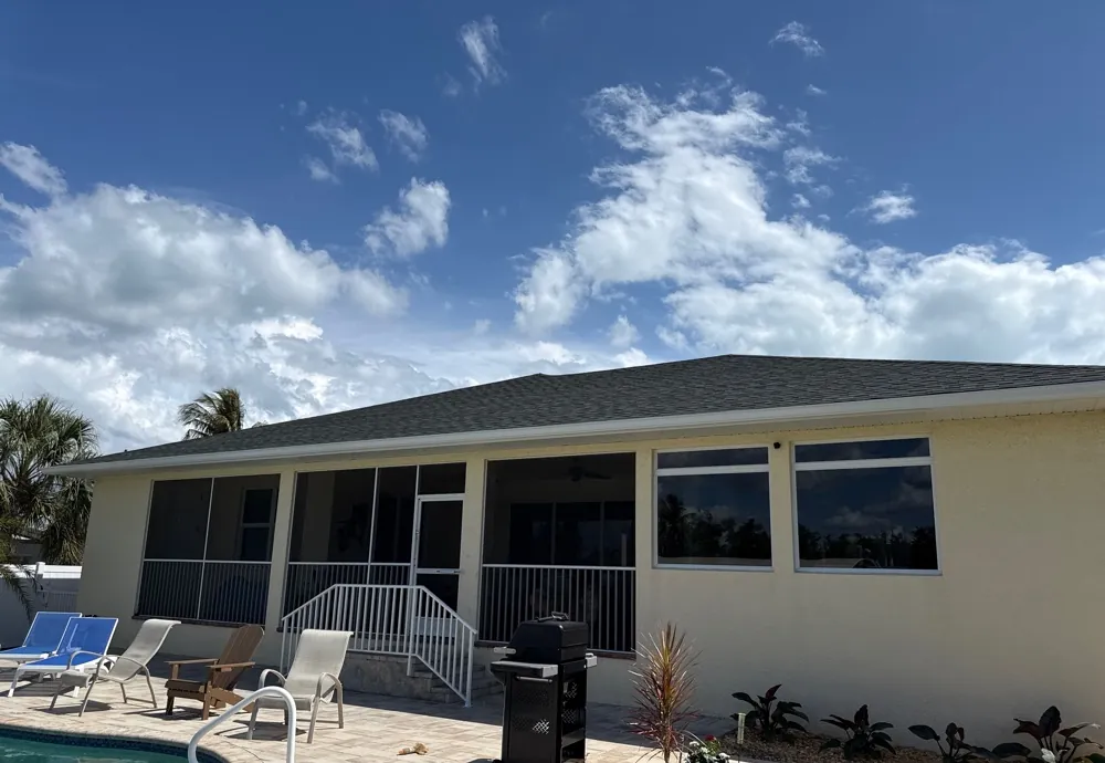 White gutters over a pool deck and screened porch in Fort Myers Beach, FL