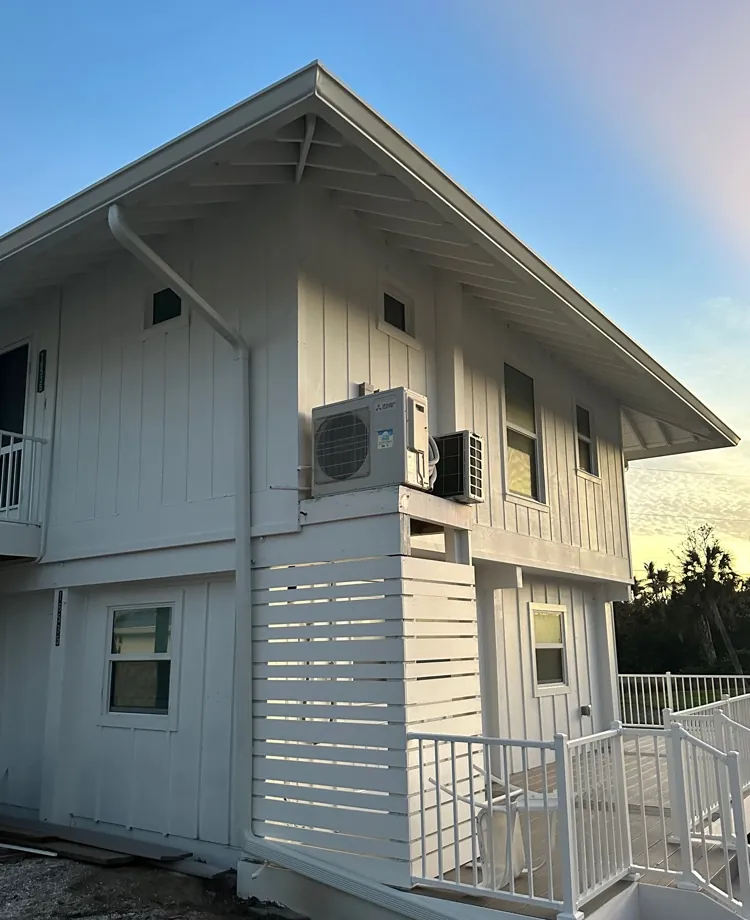 White island cottage with white gutters in Captiva, FL